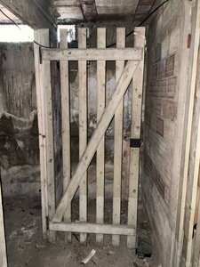 Porte de cave en lames de bois ajourées